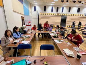 full class of learners learning silk cocoon art